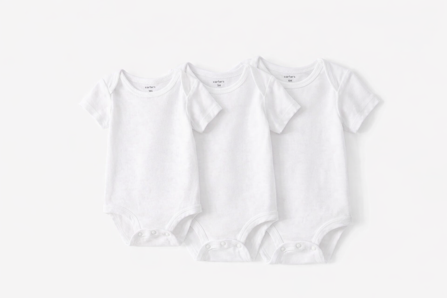 Carter's white onesie set showing all 3 sizes - Newborn, 3M, and 6M flat lay